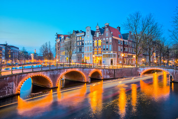 Fototapeta premium Amsterdam canals with bridge and typical dutch houses in Netherl