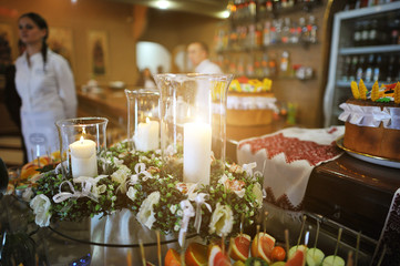 Candles on whreats at wedding reception