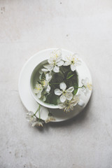 Obraz na płótnie Canvas Cherry blossom in a white cup