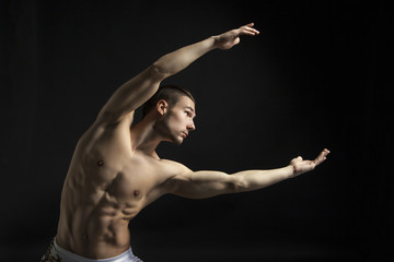 young man dancing over black