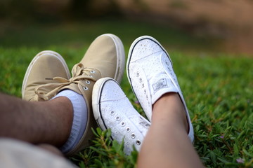 couple feet in the sport shoes in the park