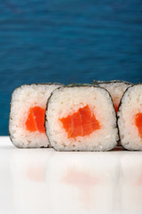 Pair of jtasty apanese rolls with salmon, rice and nori