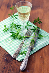 Glass with woodruff liquor on wooden table