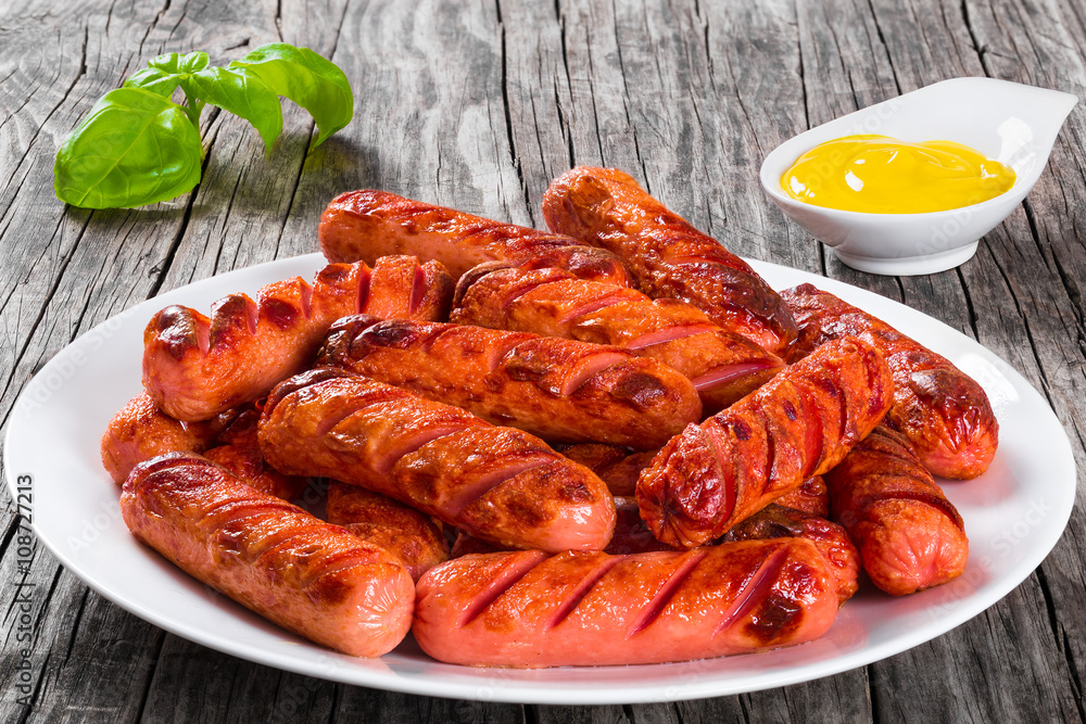 Poster grilled sausages on a white dish,