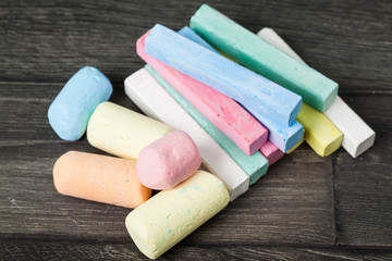 Set colorful chalks on wooden table