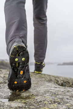 Man walking on rocky coast