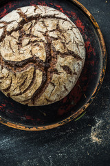 Rye bread loaf on dark slate