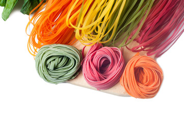 Different kinds of colorful raw italian pasta and its natural ve