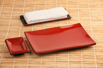 Empty dishes for sushi and rolls on a bamboo kitchen table