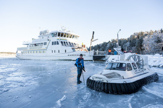 Man near boat on frozen sea