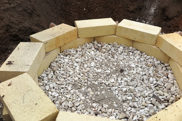 Step by step making of a fire pit using yellow aluminous bricks