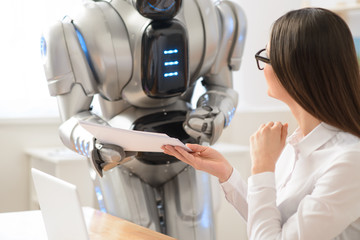 Nice girl getting papers from robot