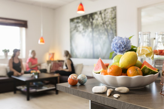 Bowl with fruits, women on background