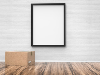 blank black frame hanging on wall with carton boxes