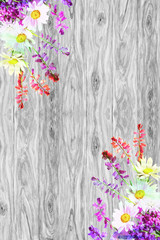 Bouquet of wild flowers is located on rustic wooden background w