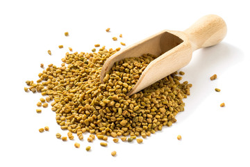 Fenugreek seeds in a wooden scoop