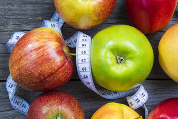 Apples with tape measure, Open notebook for notes. The concept of a healthy lifestyle and losing...