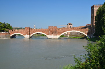 Naklejka premium Medieval stone bridge Ponte Scaligero across the river Adige and tower of Castelvecchio, Verona, Northern Italy. 