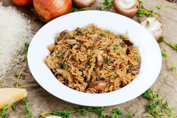 Risotto mushrooms with parmesan cheese, fresh herbs, rice, onion.