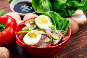 Duck noodles with egg, vegetables and duck meat in bowl