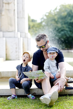 Portrait of father with sons in park