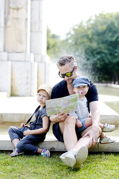 Portrait of father with sons in park
