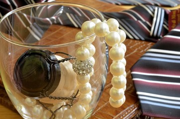 glass, tie and pearls