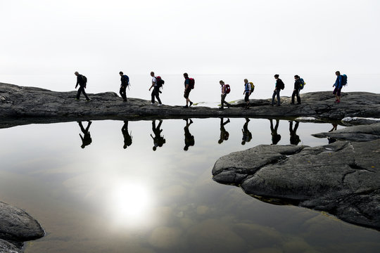 Group of people hiking by lake