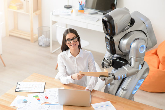 Delighted girl getting package from the robot