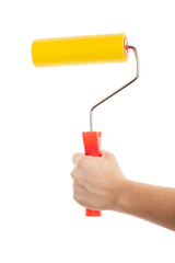 Paint roller with a red handle in the human hand. Isolated on a