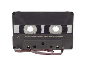 Old audio cassette isolated on white. Dusty damaged audio cassette, historical sound recording on magnetic tape. Place for your text.
