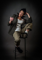Androgynous character on a gray background. Man or woman. Military style. Very sharp.  