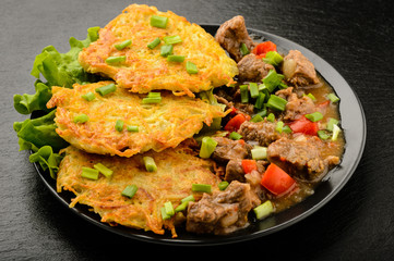 Potato pancake with goulash.