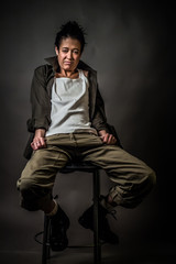 Androgynous character on a gray background. Man or woman. Military style. Very sharp.  