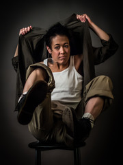 Androgynous character on a gray background. Man or woman. Military style. Very sharp.  