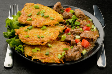 Potato pancake with goulash.
