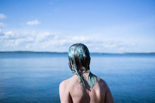 Rear view of girl by a lake