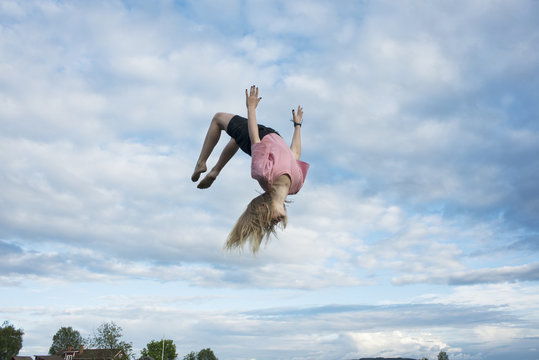 Girl doing somersault mid-air