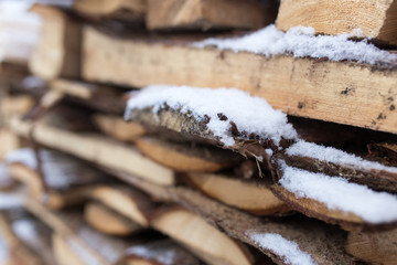 firewood in the snow in the winter