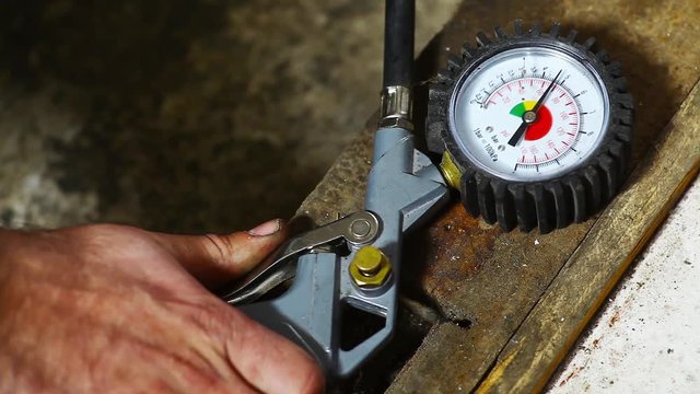 Color video of a tire pressure gauge inflating a tire.