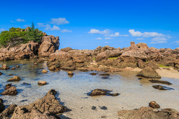 Background stone beach, with blue sky and sand