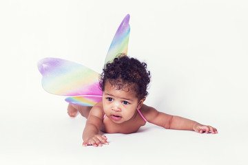 Pretty baby fairy portrait wearing colorful wings