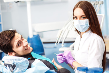 Overview of dental caries prevention.man at the dentist's chair during a dental procedure.
