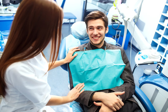 Overview of dental caries prevention. man at the dentist's chair during a dental procedure. Healthy Smile.
