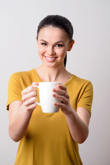 Nice girl giving you a cup of coffee 