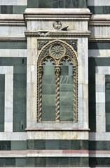 Florence Cathedral beautufil marbles. Detail from Saint Mary of the Flower southern facade with a false gothic window as decoration