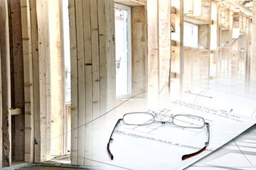 Reading Glasses on blueprints with Wood Framed Structure