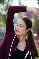 young beautiful woman stretching her arm