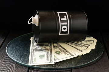 Oil business concept. Barrel of oil on dollar bills