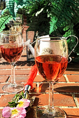 Two glasses with rose wine on a patio table